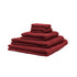 Fem økologiske håndklæder stablet oven på hinanden. Farven er rød eller bordeaux.